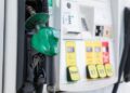 gas pump nozzle with rising numbers on the display symbolizing inflation and escalating gas prices