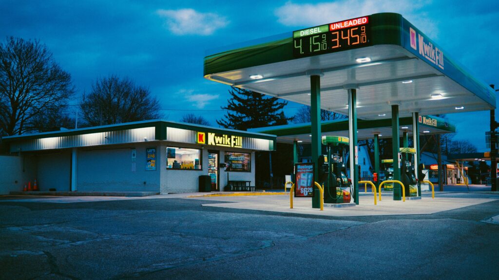 A gas station sits under the night sky.