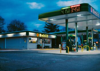 A gas station sits under the night sky.