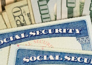 USA Social security cards laid on dollar bills
