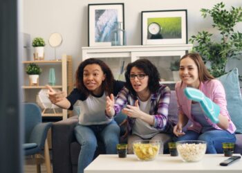 a group of women sitting on top of a couch