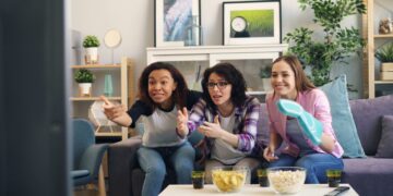 a group of women sitting on top of a couch