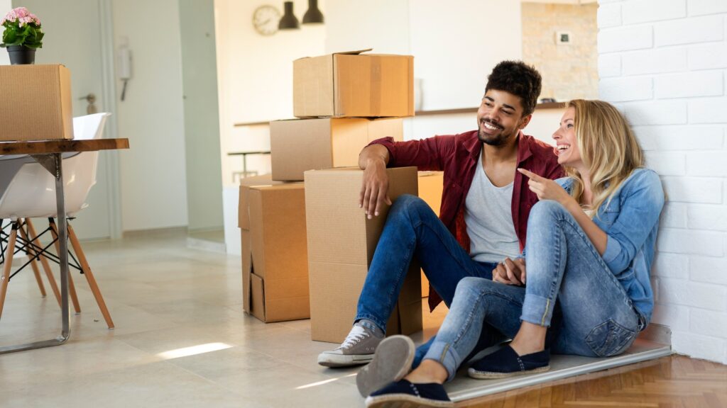Young Cute Couple Moving In To New Home Together