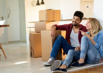 Young Cute Couple Moving In To New Home Together