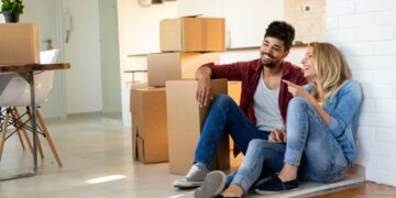 Young Cute Couple Moving In To New Home Together