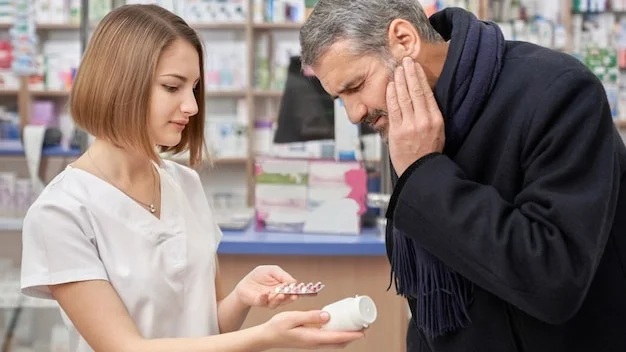 Pharmacist helping man with tooth ache in drugstore.